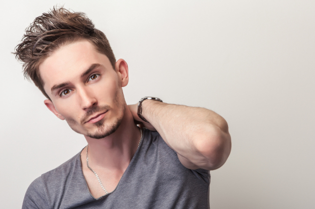 Portrait of young handsome man in grey t-shirt.
